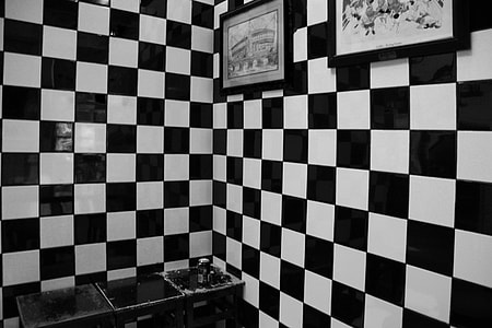 black and white checkered wall with paintings thumbnail