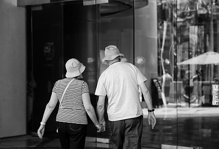 woman and man standing near glass thumbnail