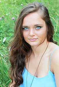 woman in blue camisole on grass field thumbnail