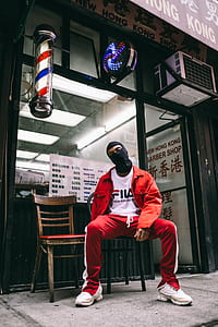 man sitting on armless chair during daytime thumbnail