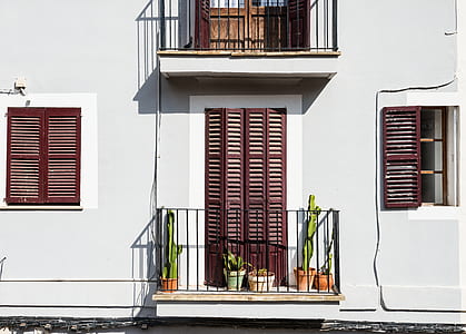 three green cacti on white building thumbnail