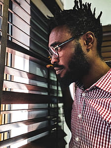 man looking at window inside house thumbnail