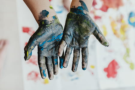 person's hand covered with paints thumbnail