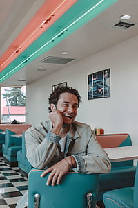 man sitting on leather chair beside table thumbnail