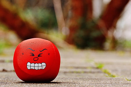 red emoji toy on gray pavement thumbnail