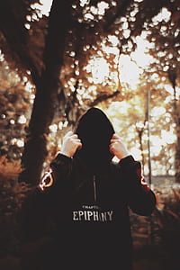 person in black pullover hoodie in tilt shift photography thumbnail