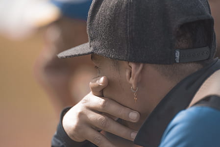 man wearing cap and touching his mouth thumbnail