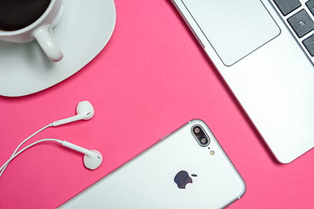 silver iPhone 7 Plus beside cup coffee and MacBook thumbnail