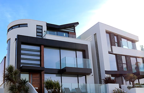 white and brown concrete house under blue sky during daytime thumbnail