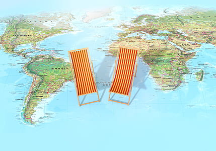 photo of two brown wooden lounge chairs on world map thumbnail