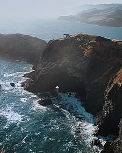 aerial view of mountain and body of water thumbnail