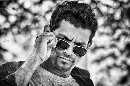grayscale photography of man in aviator sunglasses thumbnail