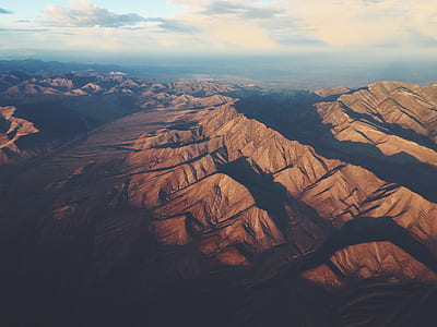 brown mountains under white clouds during daytime thumbnail