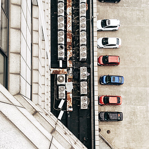 seven cars parked in front of white building top view photography during daytime thumbnail