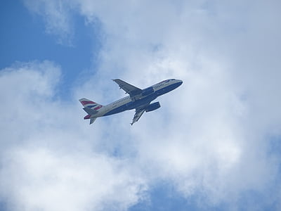 flying white and blue airplane under white clouds thumbnail