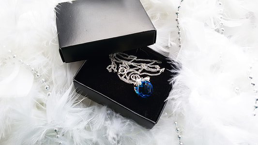 silver-colored necklace with blue gemstone in box thumbnail