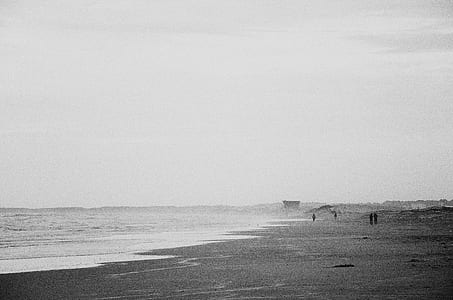 grayscale photography of four person on seashore thumbnail