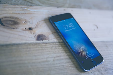 Space Gray Iphone on Wooden Surface thumbnail