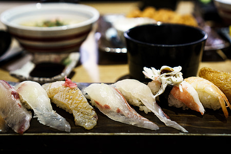 assorted sushi served on brown plate thumbnail