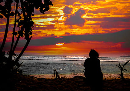 person sitting in front of seashore thumbnail