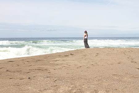 woman standing beside shore during daytime thumbnail