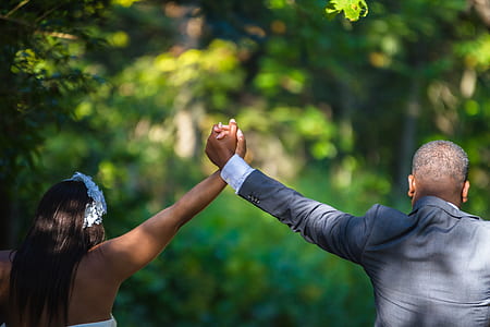 selective focus photography of couple holding hands thumbnail