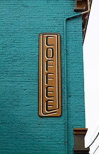 coffee signage mounted on teal concrete wall thumbnail
