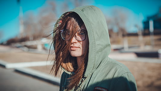 woman wearing eyeglasses standing near tree thumbnail
