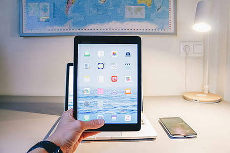 person holding black tablet computer thumbnail