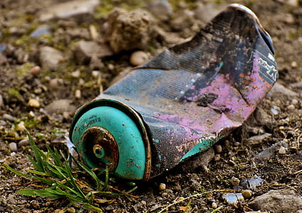 close-up photography of black and teal spray can thumbnail
