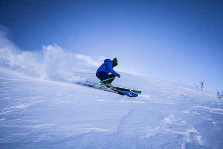 person riding snow skis on snow covered mountain thumbnail