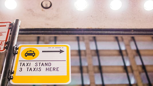selective focus photography of Taxi Stand 3 Taxis here signboard thumbnail