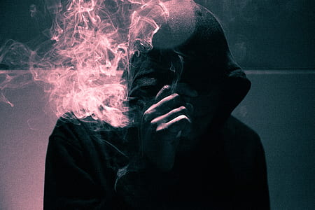 man smoking in a dim-lit room thumbnail