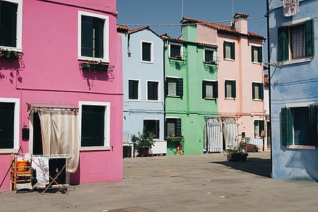 assorted-color concrete houses under blue sky thumbnail
