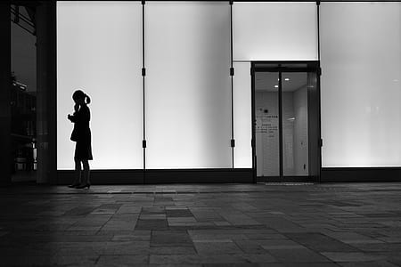 woman standing near white glass window thumbnail