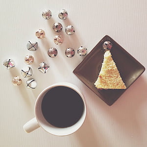 plate of sliced cake beside cup of coffee near jingle bells thumbnail