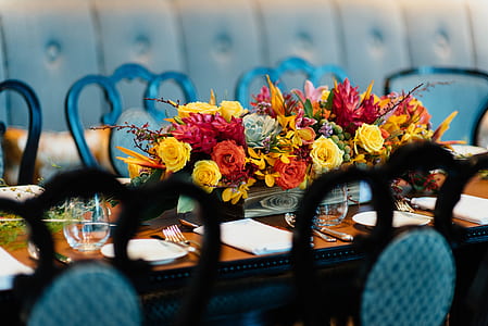 red and yellow petaled flower arrangement on top table thumbnail