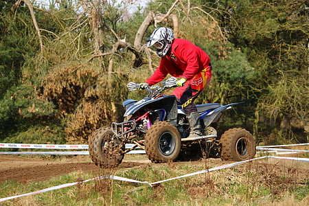 man riding ATV on grass field thumbnail