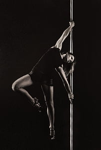 woman pole dancing during night time thumbnail