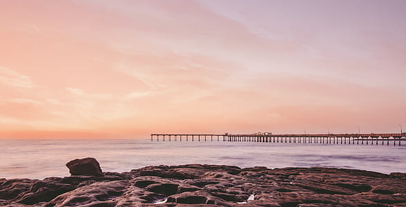 photo of beach dock under cloudy sky thumbnail