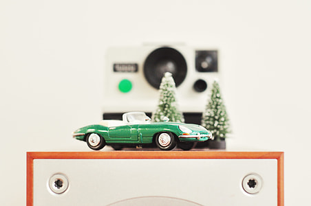 tilt shift lens photography of green car die-cast model thumbnail