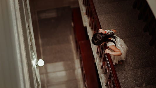 Girl in White Dress Standing in Front of Railings thumbnail