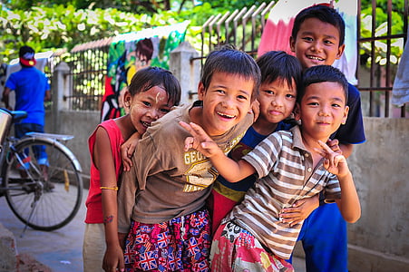 selective focus photography of group of kids on street near gray concrete fence thumbnail
