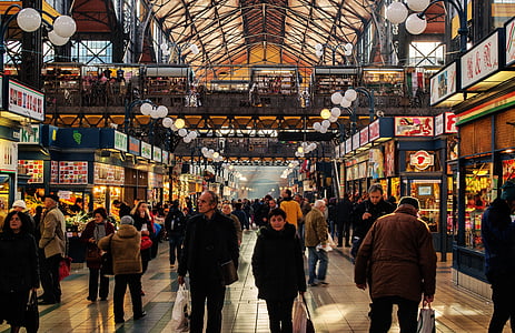 man wearing black jacket surround by stores thumbnail