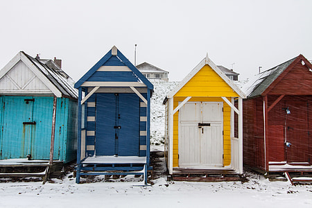 Winter-time scene of snow covered beach huts on the Kent Coast in Southern England thumbnail