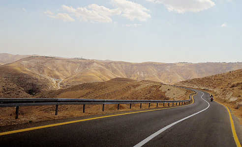 concrete road towards hills thumbnail
