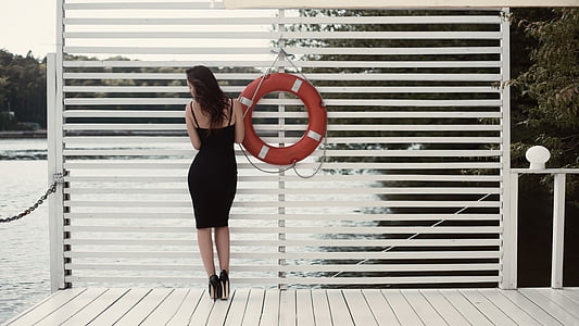 woman standing beside ocean thumbnail
