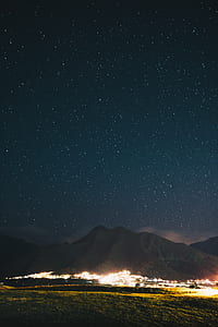 landmark photography of mountain and city lights during nighttime thumbnail