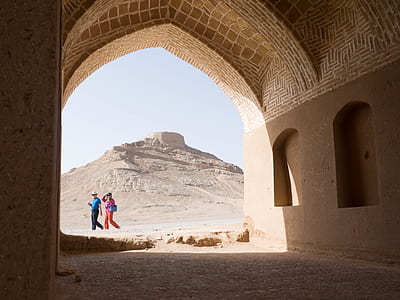 two people walking near concrete hallway thumbnail