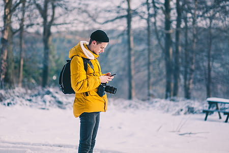 selective focus photography of man using smartphone outdoor thumbnail